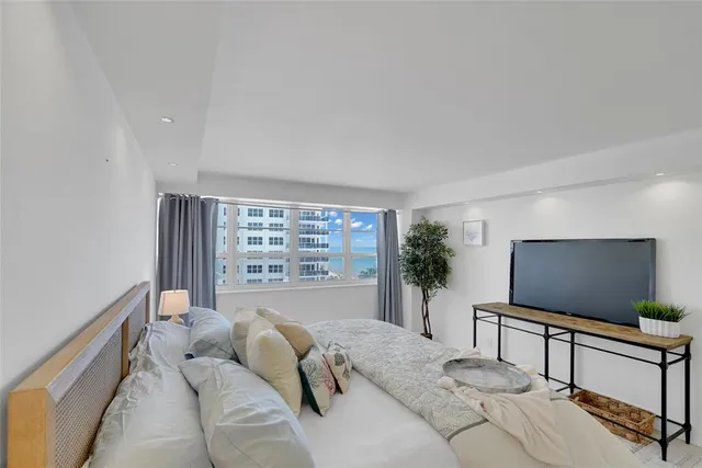 a view of a floor to ceiling window and an ocean view