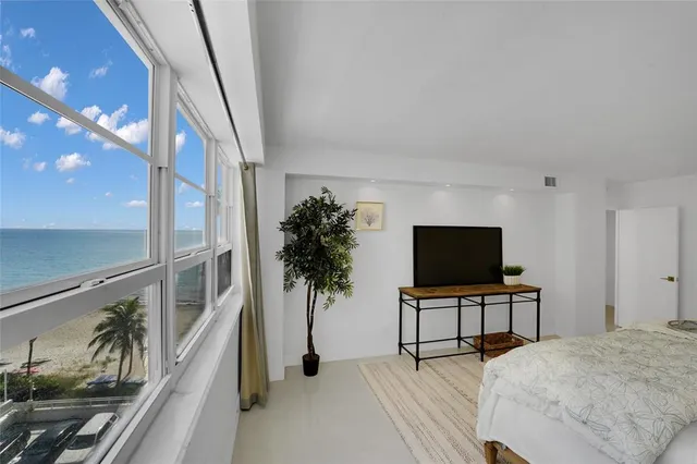 a view of a living room and a floor to ceiling window