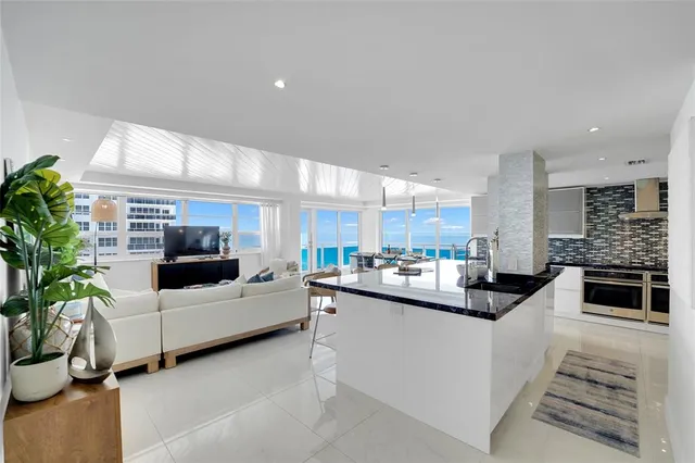 a kitchen with stainless steel appliances granite countertop a sink a stove and a wooden floors