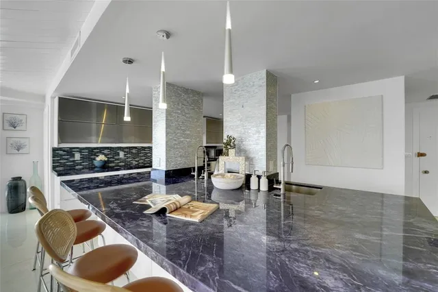 a kitchen with stainless steel appliances granite countertop a sink stove and cabinets