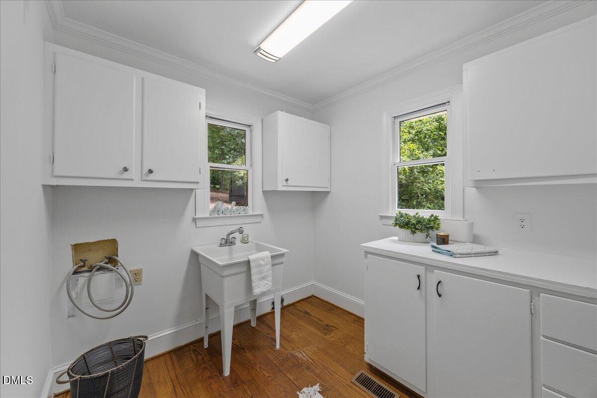 6516 Bakersfield Drive Raleigh, NC 27606 - Photo 30 of 59 a room with a sink cabinets and a window