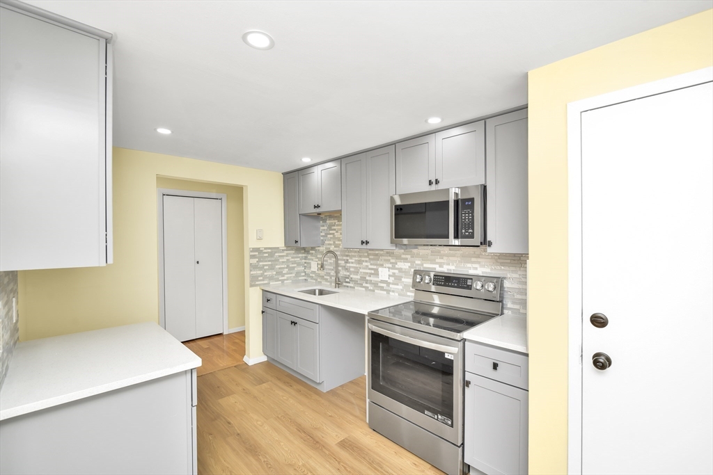 11 Greendale Road, Unit 2 Boston, MA 02126 - Photo 7 of 25 a kitchen with stainless steel appliances a sink stove and refrigerator