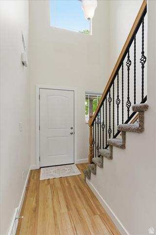 2082 Evans Cove Loop Layton, UT 84041 - Photo 2 of 25 Foyer entrance with a high ceiling and light wood-type flooring