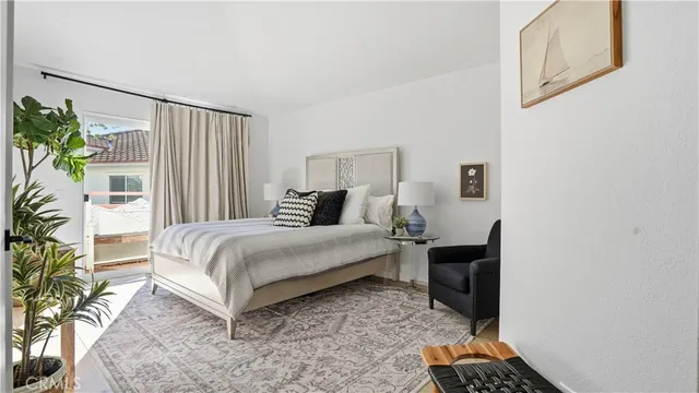 a bedroom with a bed table and a couch