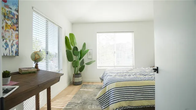 a view of bedroom with wooden floor