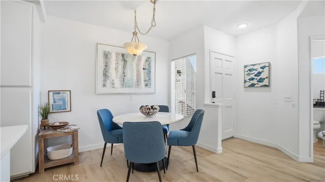 a dining room with furniture a chandelier and wooden floor