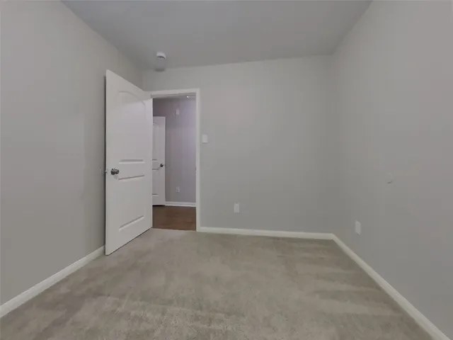 a view of an empty room and a window