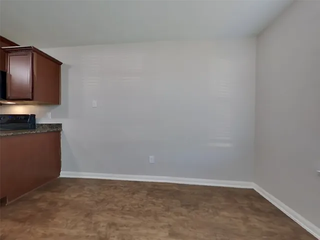 a room with a microwave and cabinets