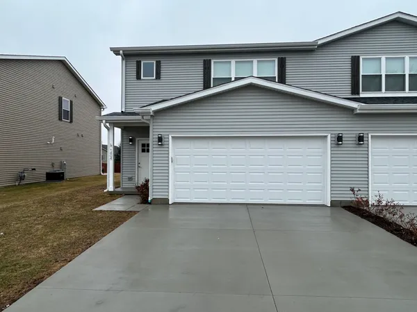 a front view of a house with a garage