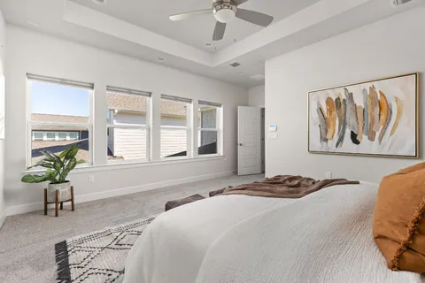 a bedroom with a bed and ceiling fan