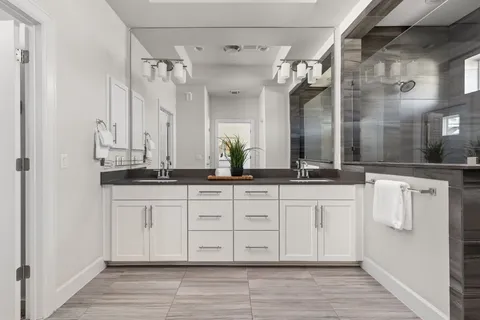 a spacious bathroom with a double vanity sink and a mirror