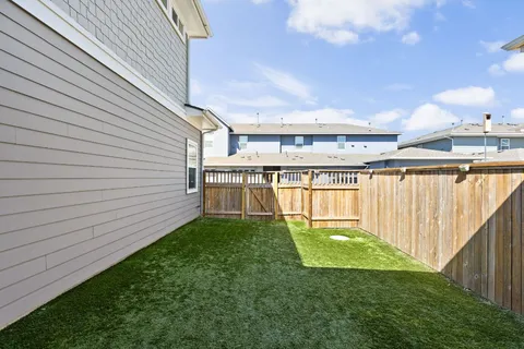 a view of a patio with table and chairs and potted plants