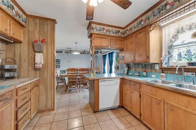 a kitchen with cabinets and chairs