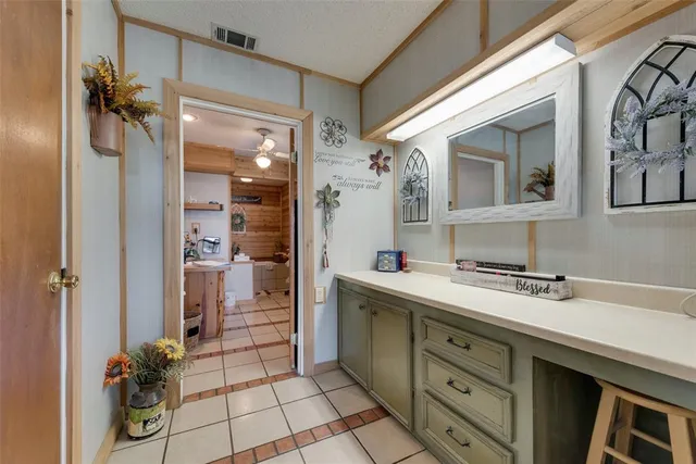 a spacious bathroom with a sink a mirror and a shower