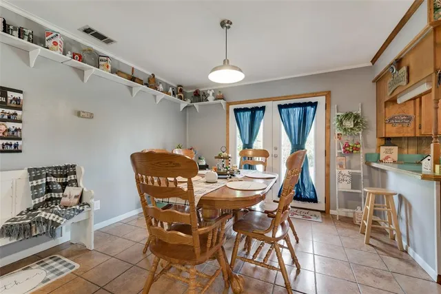 a view of a dining room with furniture and chandelier