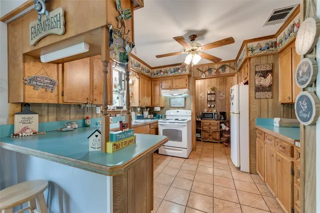 a kitchen with a sink a counter top space cabinets and stainless steel appliances
