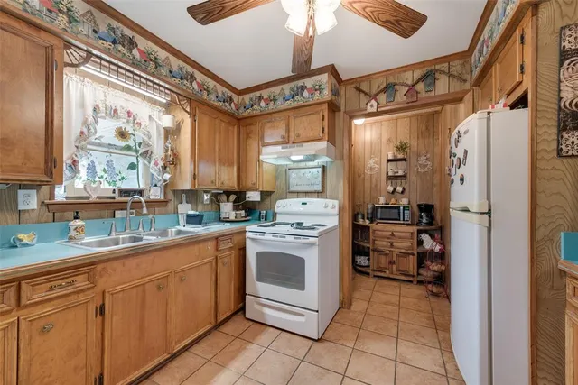a kitchen with stainless steel appliances a stove sink and refrigerator