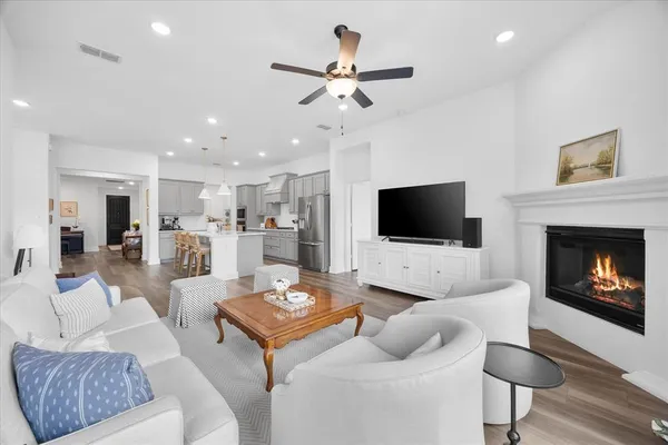 a living room with furniture fireplace and a flat screen tv