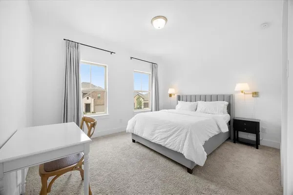 a bedroom with a bed and a couch