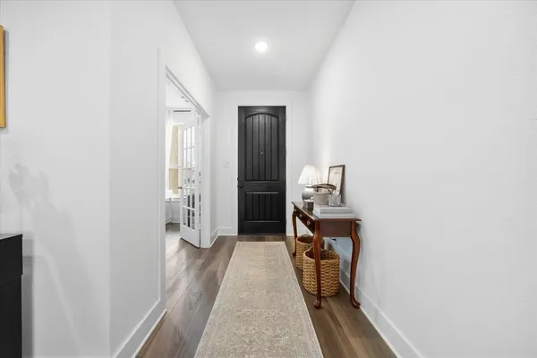 a view of hallway with wooden floor