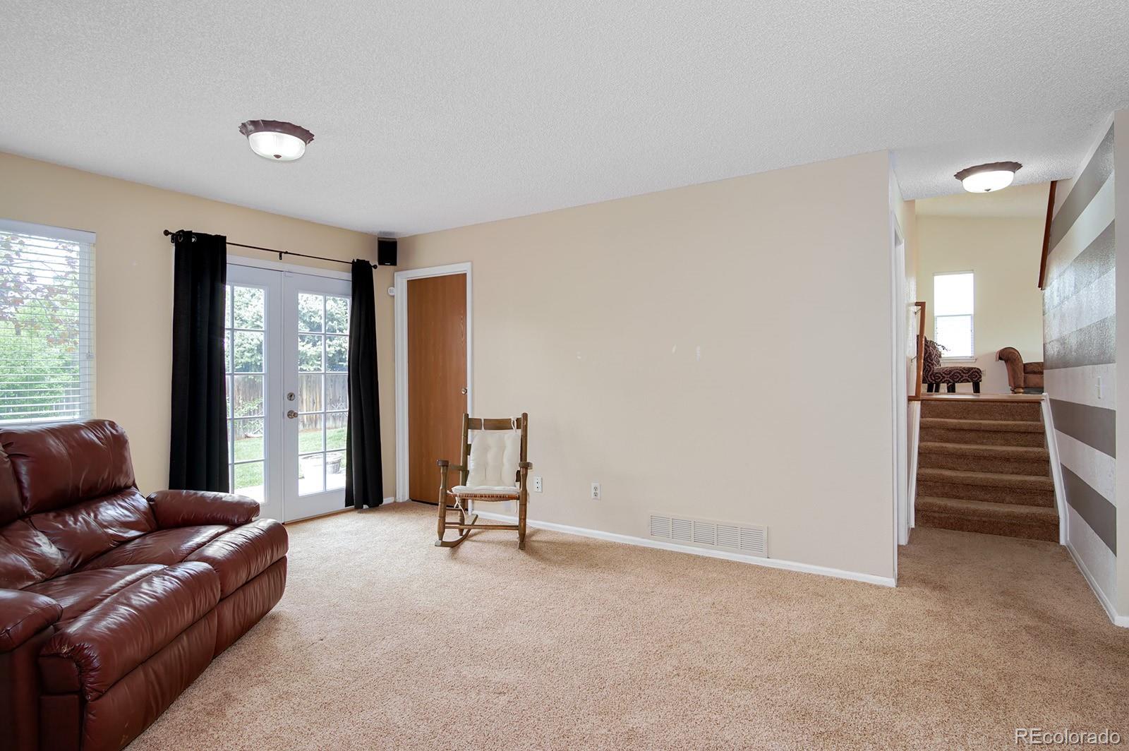 417 Ridgeglen Way Highlands Ranch, CO 80126 - Photo 14 of 33 a living room with furniture and a window