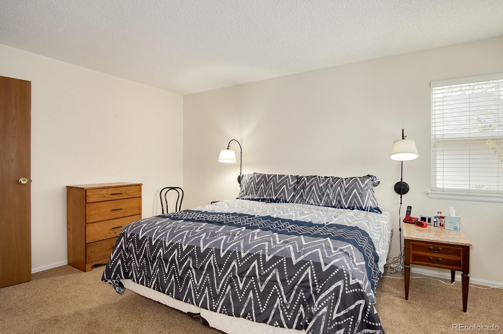 417 Ridgeglen Way Highlands Ranch, CO 80126 - Photo 16 of 33 a bedroom with a bed and window