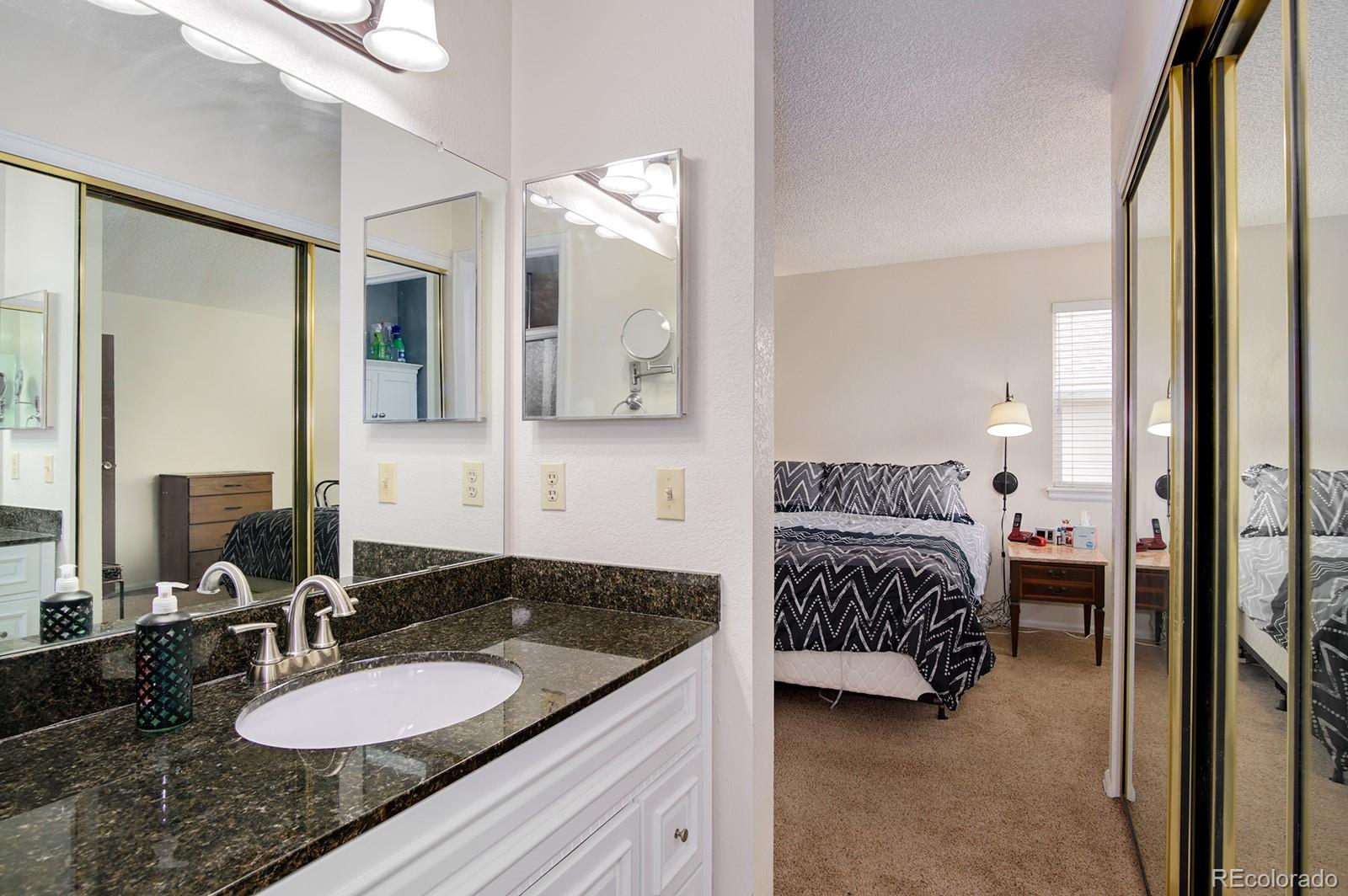 417 Ridgeglen Way Highlands Ranch, CO 80126 - Photo 18 of 33 a en suite bathroom with a granite countertop sink and mirror