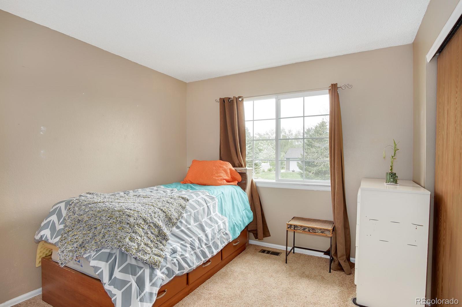 417 Ridgeglen Way Highlands Ranch, CO 80126 - Photo 19 of 33 a bedroom with a bed and a window