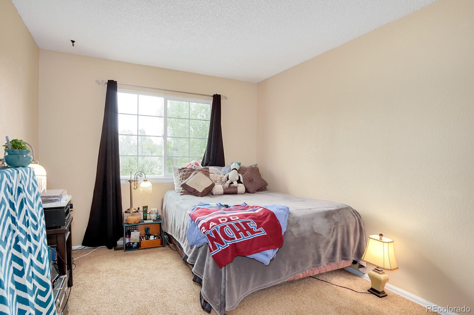 417 Ridgeglen Way Highlands Ranch, CO 80126 - Photo 20 of 33 a bedroom with a bed and a window