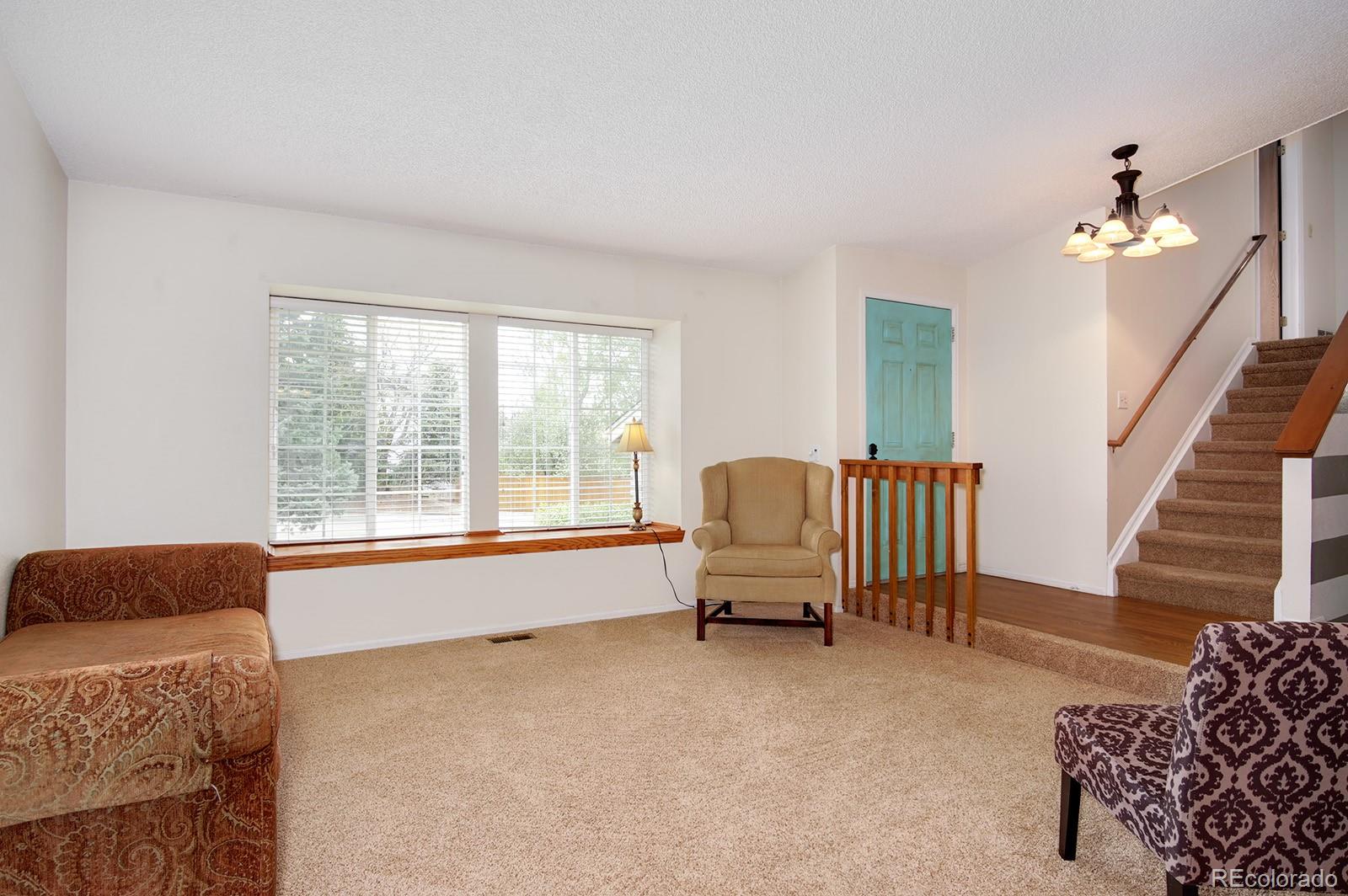 417 Ridgeglen Way Highlands Ranch, CO 80126 - Photo 2 of 33 a living room with furniture and stairs
