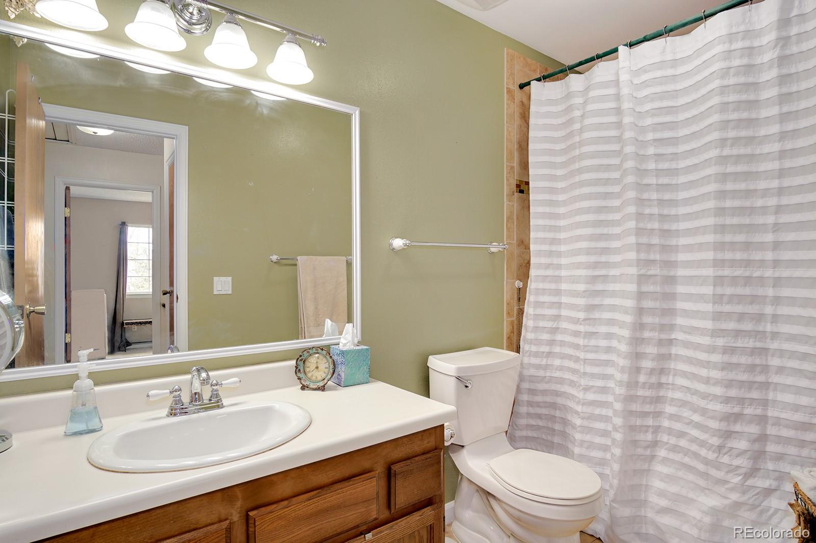 417 Ridgeglen Way Highlands Ranch, CO 80126 - Photo 21 of 33 a bathroom with a toilet a sink and a mirror
