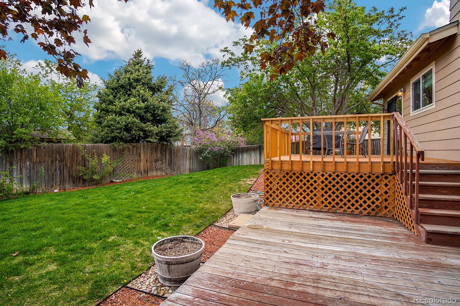 417 Ridgeglen Way Highlands Ranch, CO 80126 - Photo 30 of 33 a view of a wooden deck with a bench
