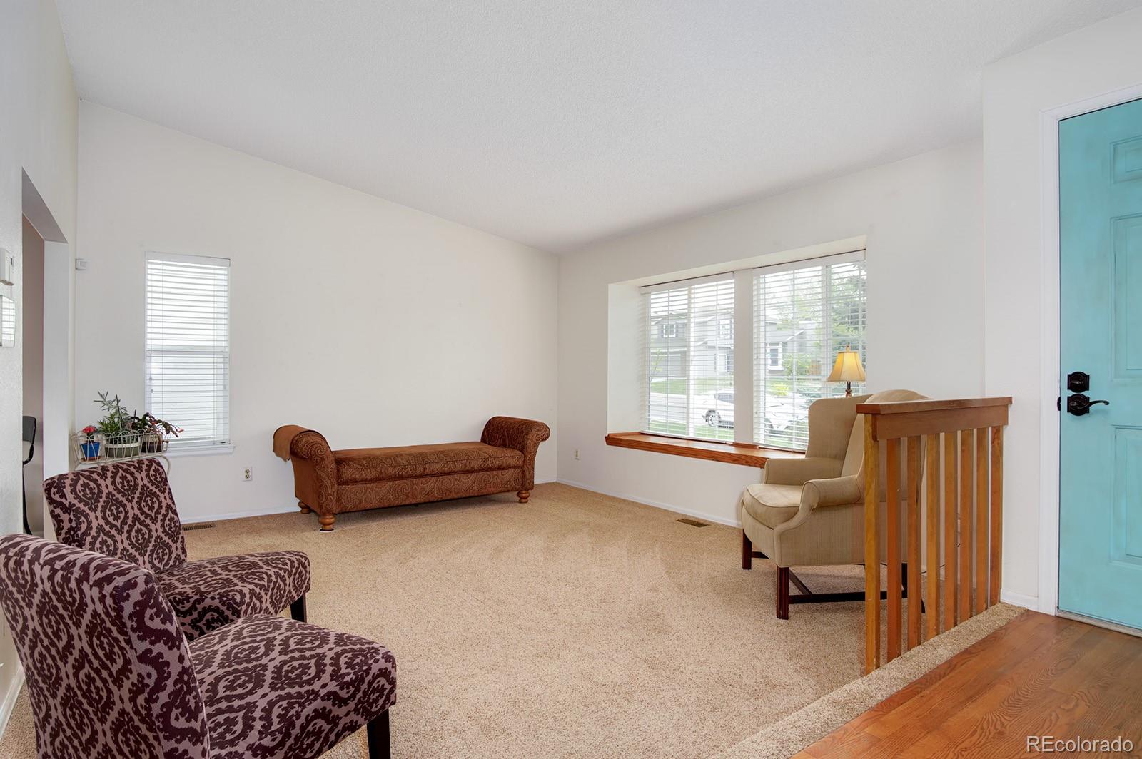 417 Ridgeglen Way Highlands Ranch, CO 80126 - Photo 3 of 33 a living room with furniture and a window