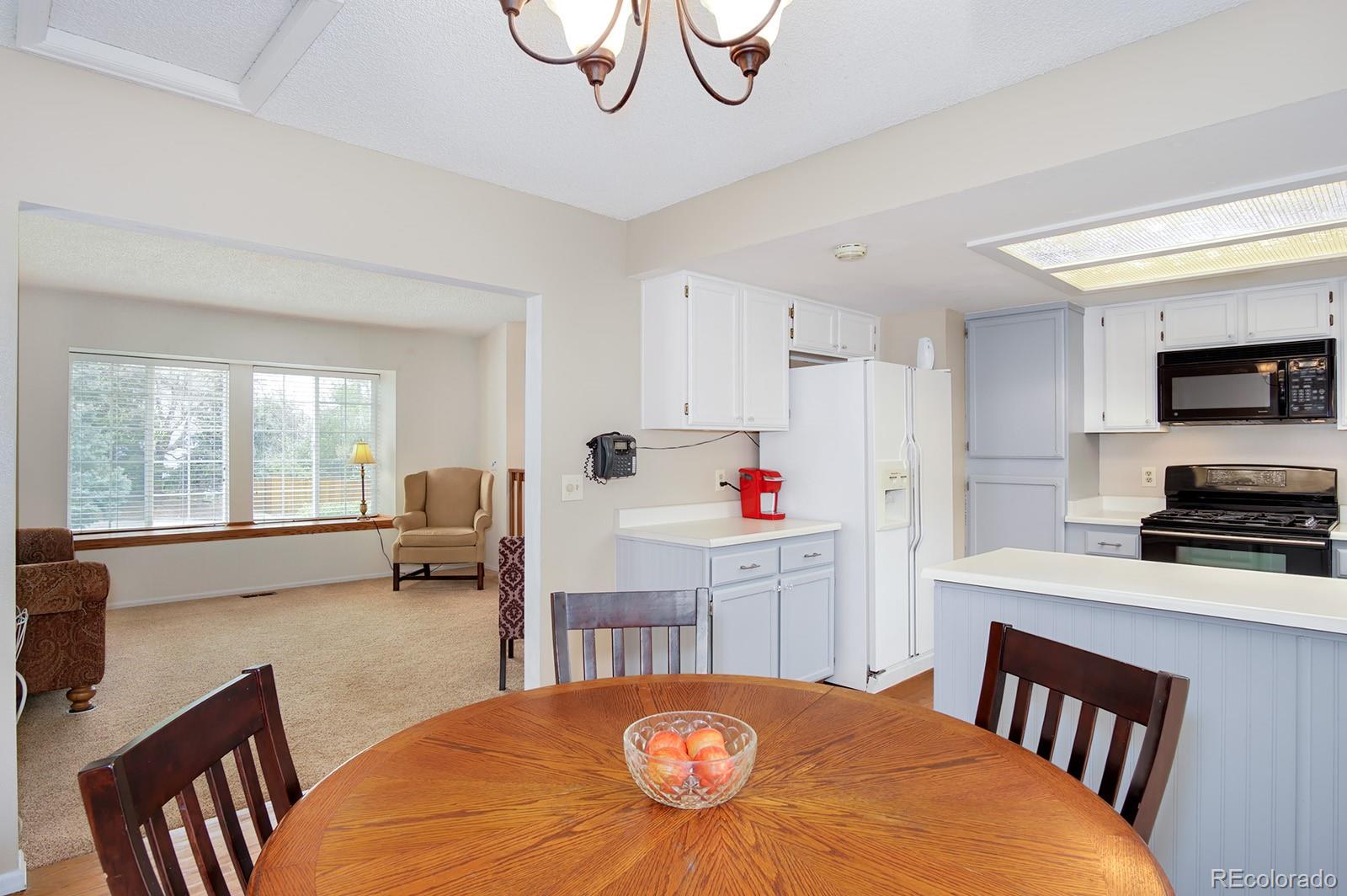 417 Ridgeglen Way Highlands Ranch, CO 80126 - Photo 6 of 33 a kitchen that has a dining table and chairs in it