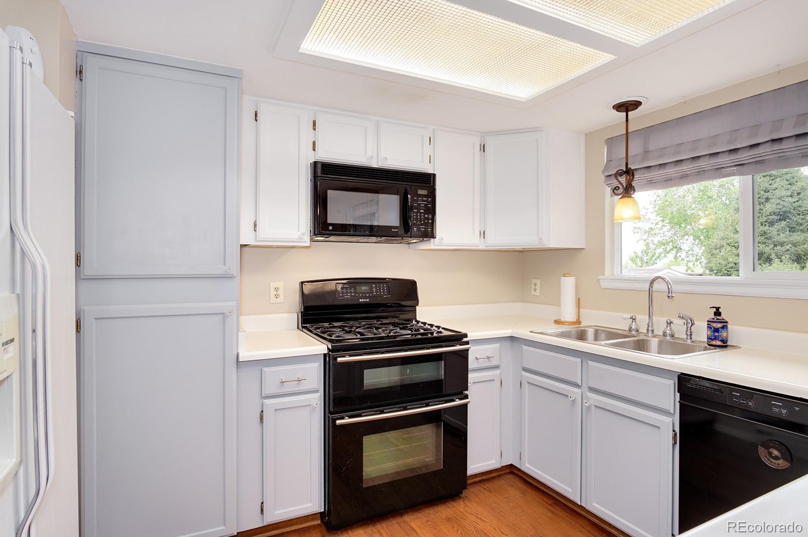417 Ridgeglen Way Highlands Ranch, CO 80126 - Photo 7 of 33 a kitchen with a sink stove and microwave