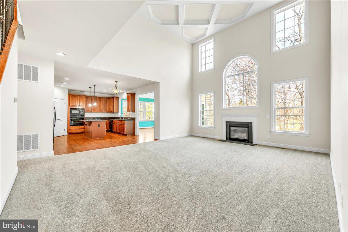 9588 Clover Hill Road Manassas, VA 20110 - Photo 11 of 32 a view of an empty room with a fireplace and a window