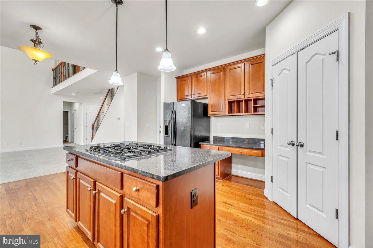 9588 Clover Hill Road Manassas, VA 20110 - Photo 14 of 32 a kitchen with stainless steel appliances granite countertop a sink a stove and a refrigerator