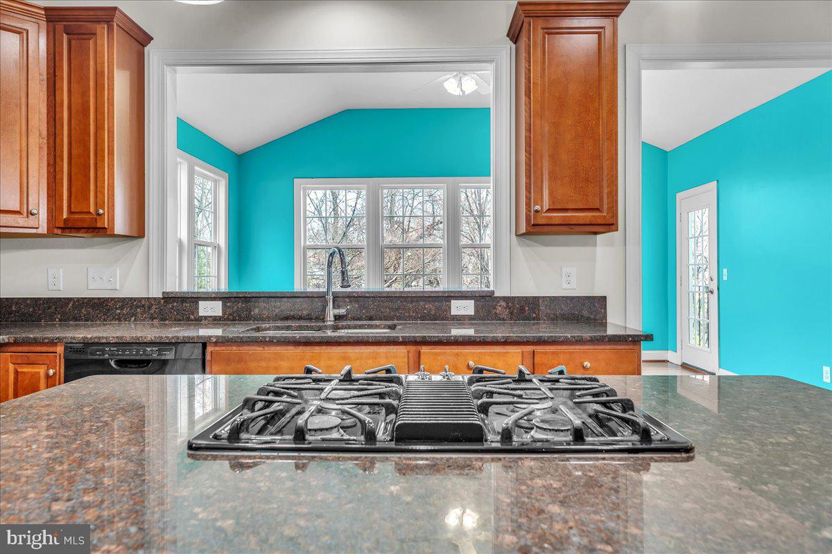 9588 Clover Hill Road Manassas, VA 20110 - Photo 15 of 32 a kitchen with stainless steel appliances granite countertop a sink stove and cabinets