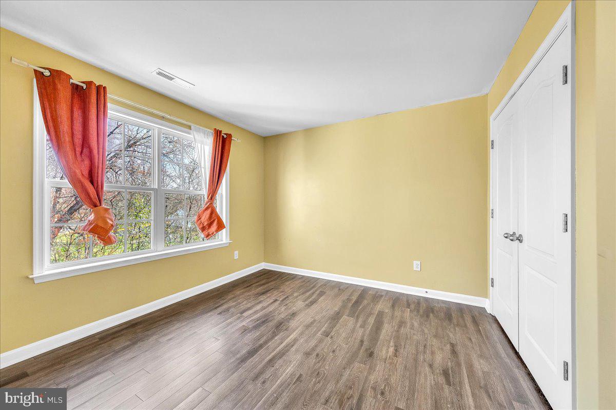 9588 Clover Hill Road Manassas, VA 20110 - Photo 26 of 32 a view of a room with wooden floor and a window