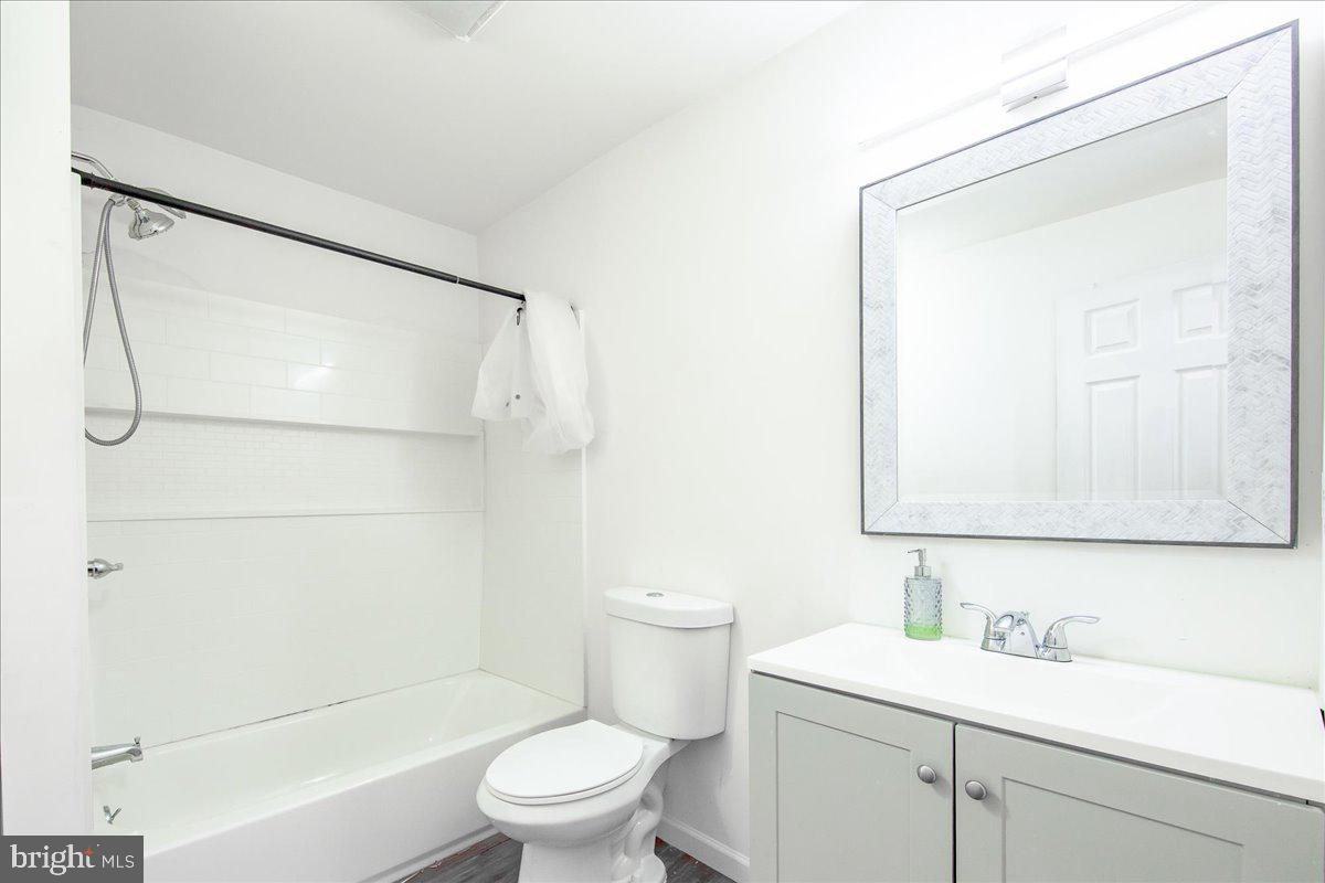 9588 Clover Hill Road Manassas, VA 20110 - Photo 32 of 32 a bathroom with a sink a toilet and shower