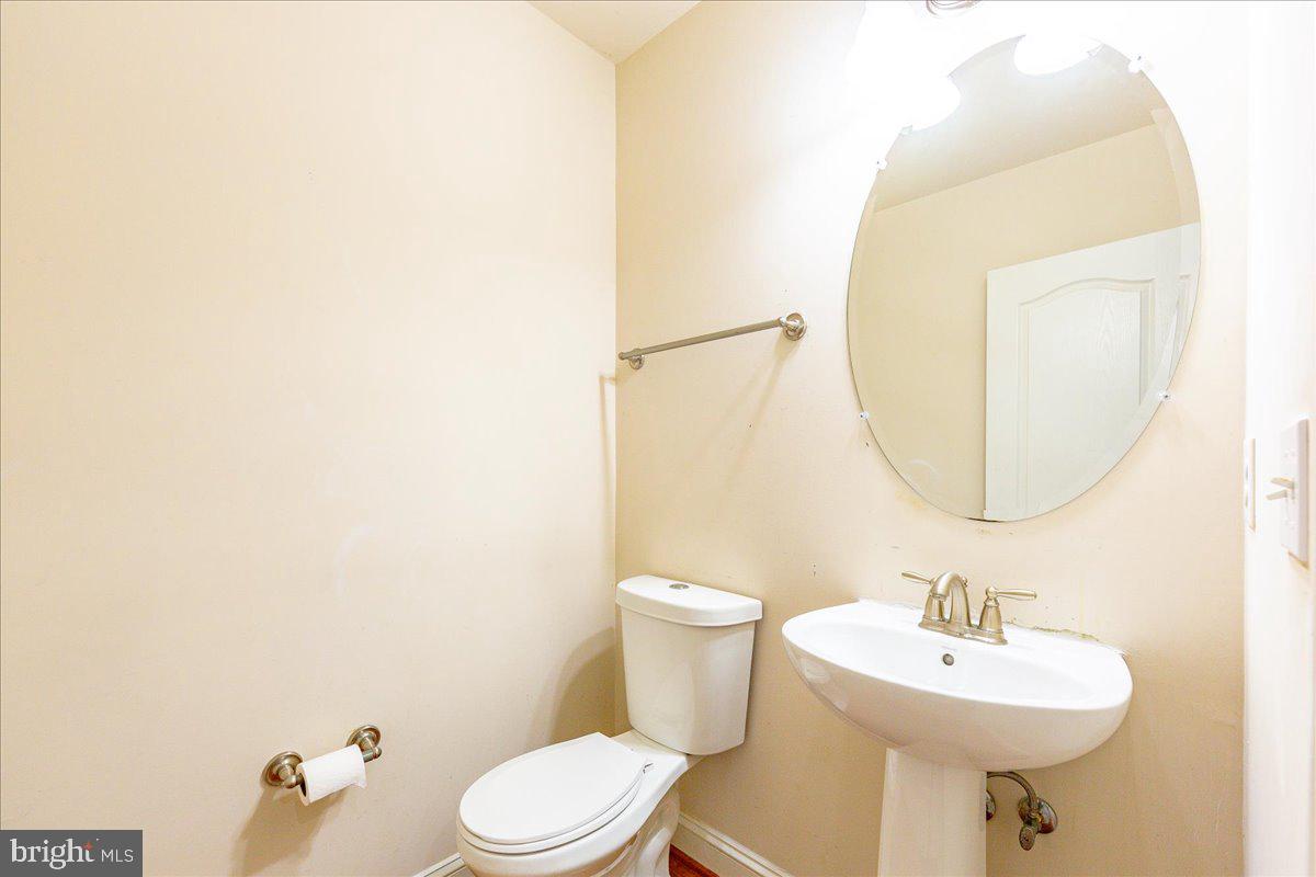 9588 Clover Hill Road Manassas, VA 20110 - Photo 9 of 32 a bathroom with a sink a mirror and a toilet