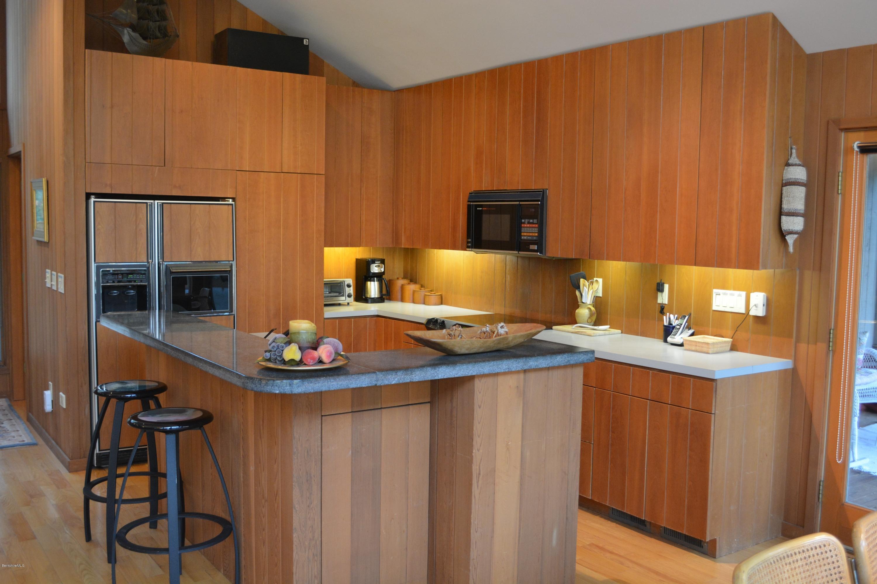 138 Bonny Rigg Hill Road Becket, MA 01223 - Photo 11 of 39 a kitchen with sink cabinets and chair