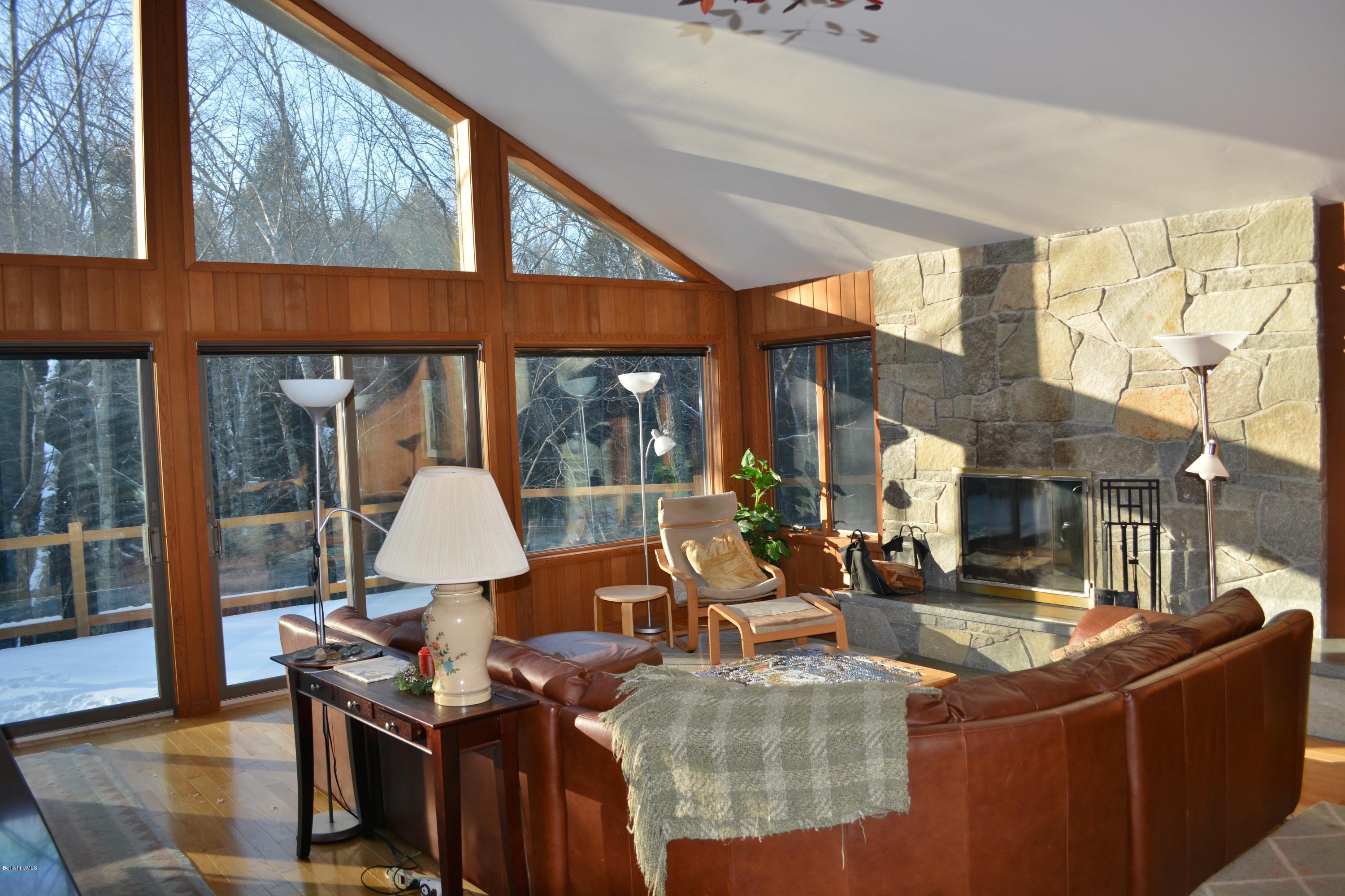 138 Bonny Rigg Hill Road Becket, MA 01223 - Photo 18 of 39 a living room with couches a fireplace with wooden floor