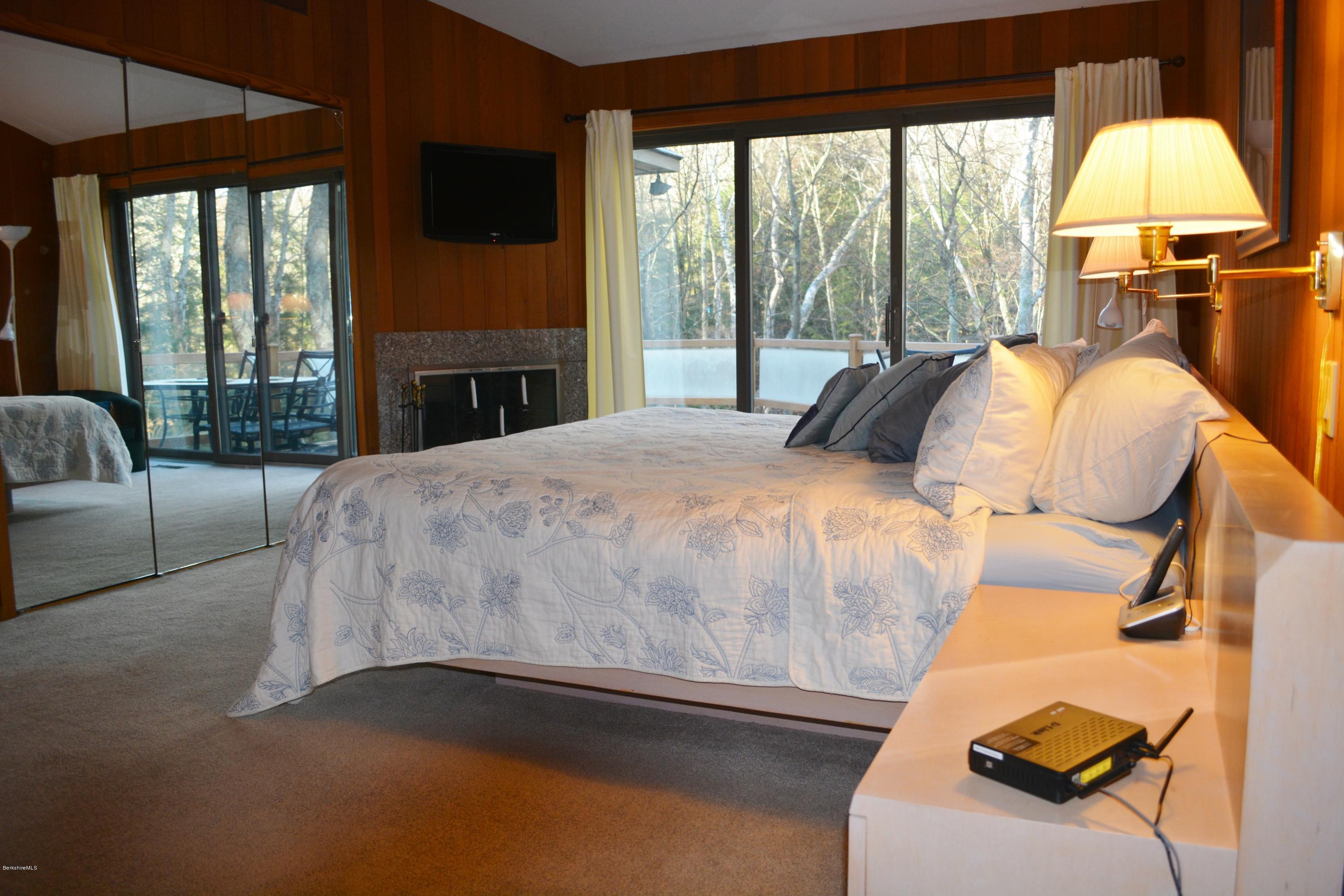 138 Bonny Rigg Hill Road Becket, MA 01223 - Photo 20 of 39 a bedroom with a bed and a fireplace
