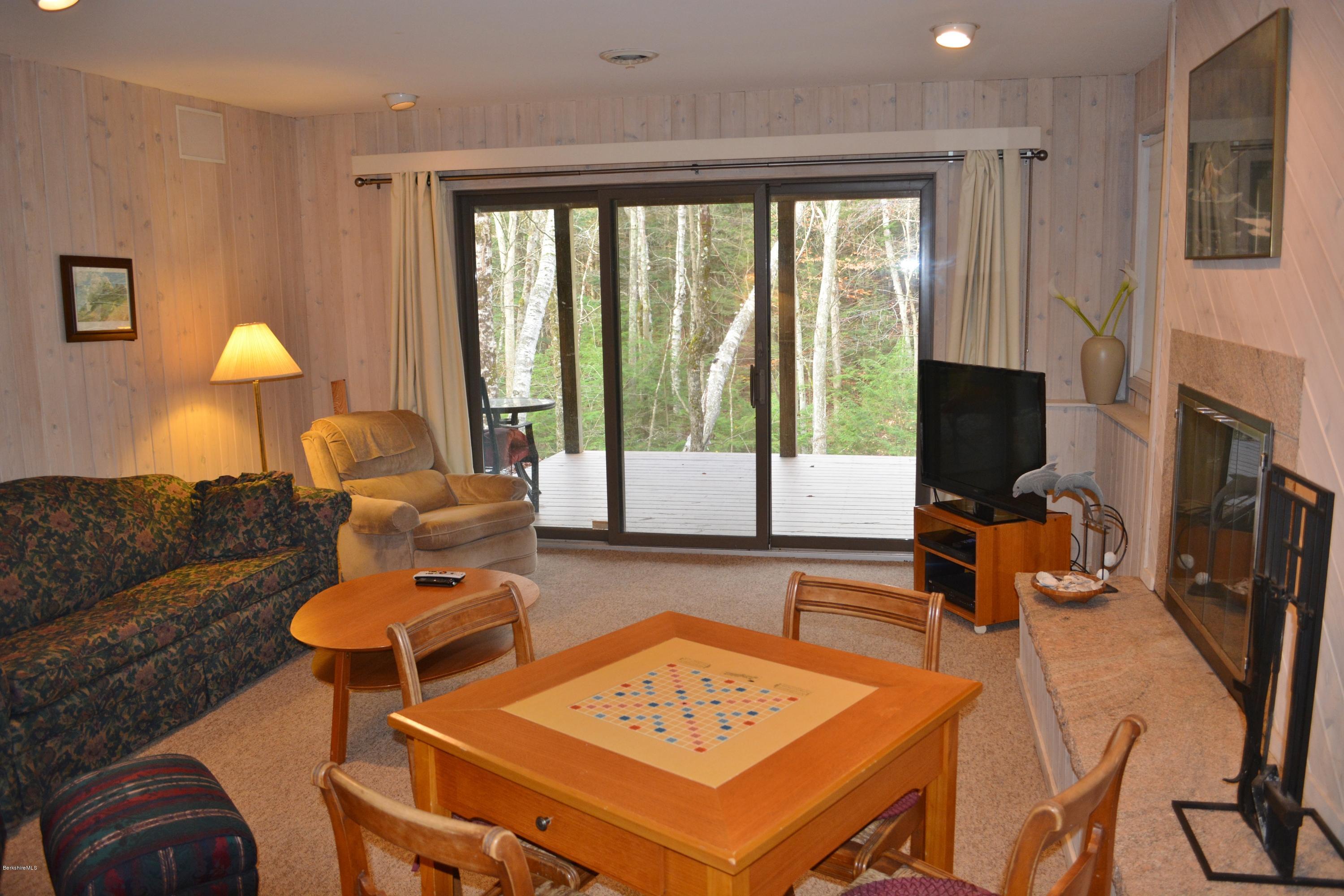 138 Bonny Rigg Hill Road Becket, MA 01223 - Photo 26 of 39 a living room with furniture a flat screen tv and a fireplace