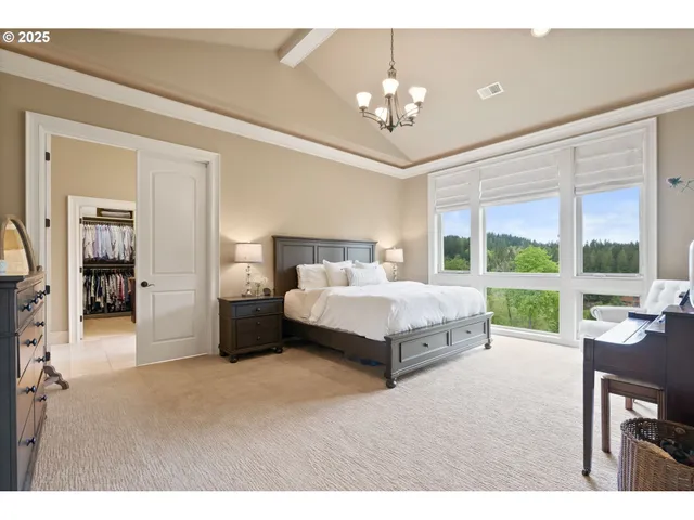 a spacious bedroom with a bed and a large window