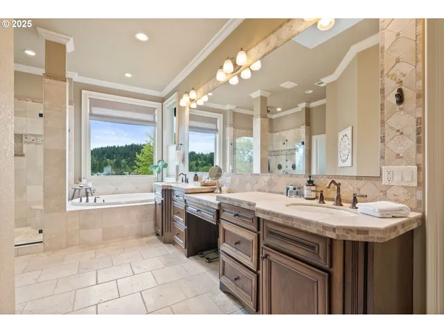 a bathroom with a sink a large mirror and a bathtub with shower