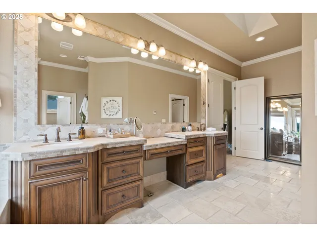 a view of a double vanity sink mirror and cabinets