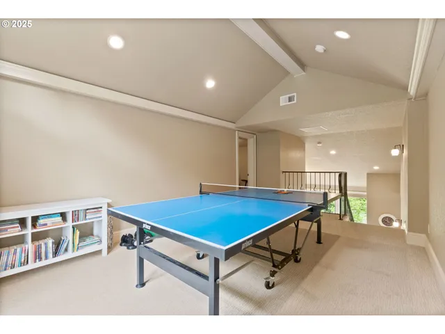 a room with pool table and windows