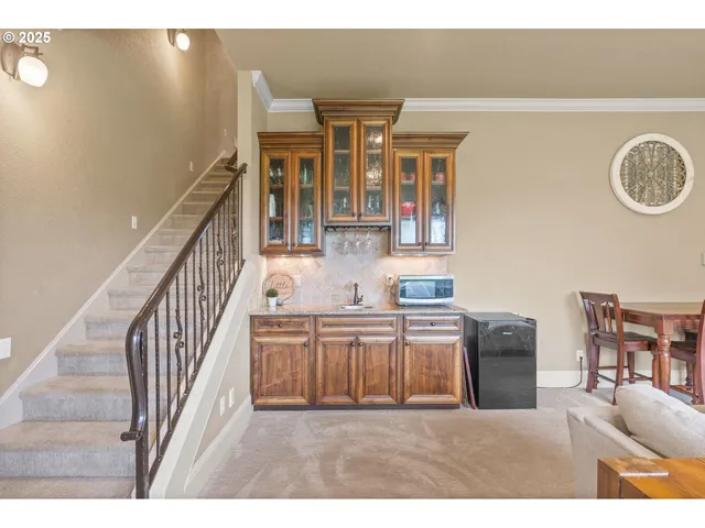 a view of a kitchen with furniture and wooden floor